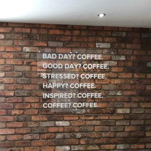 Acrylic sign on stand-off locators mounted to wall
